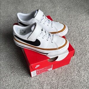 Nike Kids White Sneakers with Black Swoosh and Brown Trim